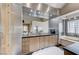 The bathroom offers dual sinks, modern cabinets, and a walk-in shower and separate soaking tub for ultimate relaxation at 8121 Castle Pines Ave, Las Vegas, NV 89113