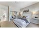 Bright bedroom features a white platform bed, mirrored closet doors and stylish decor at 8121 Castle Pines Ave, Las Vegas, NV 89113