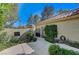 Lush landscaping adorns the walkway of this home with a gated entrance at 8121 Castle Pines Ave, Las Vegas, NV 89113