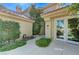 A front patio leads to the entrance of this home that is surrounded by greenery at 8121 Castle Pines Ave, Las Vegas, NV 89113