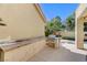 Exterior view of outdoor grill and sink area with access to covered patio at 8121 Castle Pines Ave, Las Vegas, NV 89113