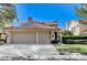 Charming home with a two-car garage, a red tile roof, and a neatly manicured lawn at 8121 Castle Pines Ave, Las Vegas, NV 89113