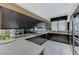 Gourmet kitchen featuring elegant dark cabinets, stainless steel appliances, and ample counter space at 8121 Castle Pines Ave, Las Vegas, NV 89113