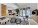 Bright living room with hardwood floors, modern seating, and pool view through glass doors at 8121 Castle Pines Ave, Las Vegas, NV 89113