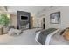 Spacious bedroom boasts a modern fireplace, a sleek chaise lounge, and comfortable furnishings, creating a cozy retreat at 8121 Castle Pines Ave, Las Vegas, NV 89113