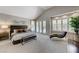 Spacious main bedroom features a vaulted ceiling, a seating area, and plenty of natural light from the large windows at 8121 Castle Pines Ave, Las Vegas, NV 89113