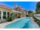 Stunning pool area with a spa and view of the home's architecture and landscaping at 8121 Castle Pines Ave, Las Vegas, NV 89113