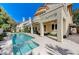 Inviting pool and spa area with a covered patio and lush landscaping, perfect for outdoor living at 8121 Castle Pines Ave, Las Vegas, NV 89113
