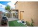 Relaxing backyard with a covered patio, artificial turf, and convenient access door to the house at 8368 Creek Canyon Ave, Las Vegas, NV 89113