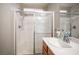 Bright bathroom features a shower with glass doors and a large single sink vanity at 8368 Creek Canyon Ave, Las Vegas, NV 89113