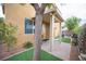 Shady covered patio with a seating area, overlooking the backyard with low-maintenance landscaping at 8368 Creek Canyon Ave, Las Vegas, NV 89113