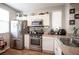 Well-lit kitchen features stainless steel appliances and light granite countertops at 8368 Creek Canyon Ave, Las Vegas, NV 89113