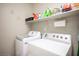 Well-equipped laundry room featuring a modern washer and dryer with overhead storage at 8368 Creek Canyon Ave, Las Vegas, NV 89113