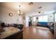 Spacious living room with wood-look floors, a ceiling fan, and ample natural light at 8368 Creek Canyon Ave, Las Vegas, NV 89113
