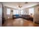 Spacious living room with wood flooring, ceiling fan, and large window views at 8368 Creek Canyon Ave, Las Vegas, NV 89113
