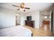 Bright primary bedroom offering a decorative ceiling fan, dresser, and attached bathroom at 8368 Creek Canyon Ave, Las Vegas, NV 89113
