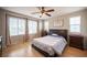 Relaxing primary bedroom featuring natural light and a decorative ceiling fan at 8368 Creek Canyon Ave, Las Vegas, NV 89113