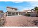 Wide view of the backyard with a covered patio and low-maintenance gravel at 8725 Russet Hills Ct, Las Vegas, NV 89147