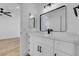 Bathroom with a single sink vanity, large framed mirror and modern fixtures at 8725 Russet Hills Ct, Las Vegas, NV 89147