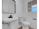 Modern half bathroom with a pedestal sink and sleek fixtures at 8725 Russet Hills Ct, Las Vegas, NV 89147