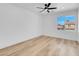 Bright bedroom with wood floors, a ceiling fan and a window at 8725 Russet Hills Ct, Las Vegas, NV 89147