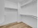 Walk-in closet featuring custom white shelving and wood look floors at 8725 Russet Hills Ct, Las Vegas, NV 89147
