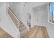 Bright entryway featuring a staircase, sleek flooring, and a modern design at 8725 Russet Hills Ct, Las Vegas, NV 89147