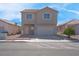 Two story home with desert landscaping, 2-car garage, and red tile roof at 8725 Russet Hills Ct, Las Vegas, NV 89147