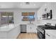 Bright kitchen showcasing stainless steel appliances, stone countertops, white cabinets, and backyard views at 8725 Russet Hills Ct, Las Vegas, NV 89147