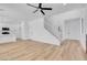 Spacious living area featuring sleek floors and a staircase leading to the upper level at 8725 Russet Hills Ct, Las Vegas, NV 89147
