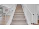 Carpeted staircase with white railing and natural light at 8725 Russet Hills Ct, Las Vegas, NV 89147