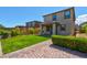 Well-maintained backyard featuring green lawn, lush shrubs, and a stone-paved pathway at 880 Cirrus Cloud Ave, Las Vegas, NV 89138
