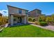 Backyard features green grass, patio, and lush landscaping at 880 Cirrus Cloud Ave, Las Vegas, NV 89138