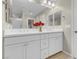 Bathroom featuring double sink vanity, a large mirror, and contemporary fixtures, complemented by neutral tones and tile flooring at 880 Cirrus Cloud Ave, Las Vegas, NV 89138
