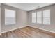 Bright bedroom features three windows and wood-look flooring at 880 Cirrus Cloud Ave, Las Vegas, NV 89138