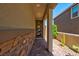 Inviting entryway with stone accent wall, brick pathway, and stylish front door with glass panels at 880 Cirrus Cloud Ave, Las Vegas, NV 89138