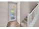 Bright entryway with stylish front door with glass panels, hardwood flooring, and staircase with white railing at 880 Cirrus Cloud Ave, Las Vegas, NV 89138