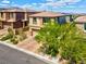 Two-story home boasts a paver driveway and mature trees at 880 Cirrus Cloud Ave, Las Vegas, NV 89138