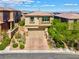 Two-story home boasts a paver driveway and mature trees at 880 Cirrus Cloud Ave, Las Vegas, NV 89138