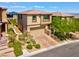 Two-story home featuring a paver driveway, manicured landscaping and neutral exterior paint at 880 Cirrus Cloud Ave, Las Vegas, NV 89138