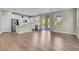 Spacious open-concept kitchen with white cabinets, stainless steel appliances, hardwood floors, and backyard access at 880 Cirrus Cloud Ave, Las Vegas, NV 89138