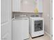 Laundry room boasts modern washer and dryer with shelving at 880 Cirrus Cloud Ave, Las Vegas, NV 89138