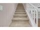 Carpeted stairs with a white railing leading to the upper level of the home at 880 Cirrus Cloud Ave, Las Vegas, NV 89138