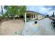 Spacious backyard with concrete patio and mature tree, offering a peaceful outdoor living space at 8928 Reining Spur Ave, Las Vegas, NV 89143