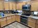 Bright kitchen featuring wooden cabinets, granite countertops, and stainless steel appliances at 8928 Reining Spur Ave, Las Vegas, NV 89143