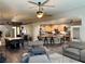Open-concept living area with kitchen, dining and seating; hardwood floors at 8928 Reining Spur Ave, Las Vegas, NV 89143