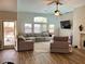 Spacious living room with a comfortable seating arrangement and views of the backyard at 8928 Reining Spur Ave, Las Vegas, NV 89143