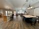 Bright, open-concept kitchen and living area with wood floors, high ceilings, and stylish barn door at 8928 Reining Spur Ave, Las Vegas, NV 89143