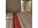 Cozy bedroom with red stripe bedding, neutral walls, and natural light at 9000 Las Vegas Blvd # 2061, Las Vegas, NV 89123