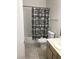 Bathroom with single vanity, tub and shower combo and checkered shower curtain at 9000 Las Vegas Blvd # 2097, Las Vegas, NV 89123